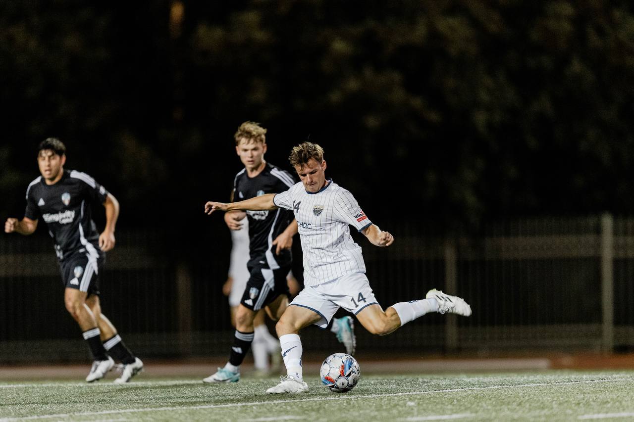 Julian Svoboda striking the ball during a night match